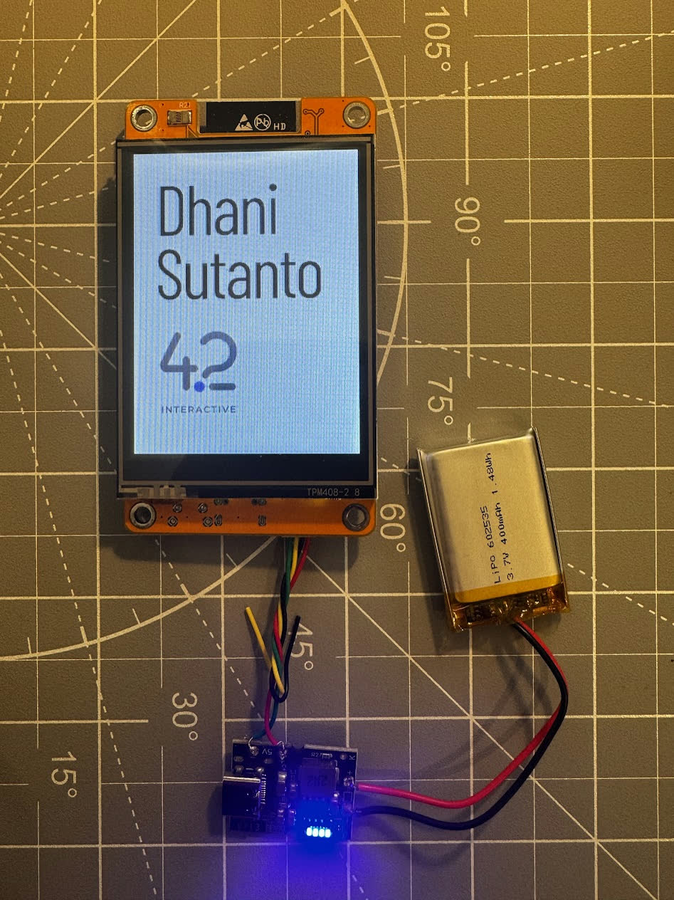 Wired prototype with the ESP32 screen displaying a name and the 42 Interactive logo
