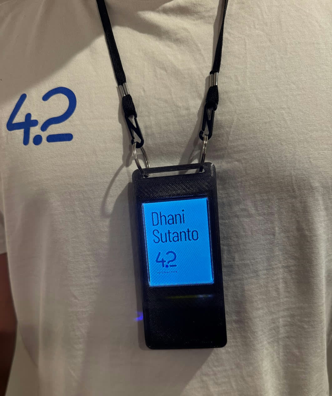 Badge worn on a lanyard, displaying a name and the 42 Interactive logo
